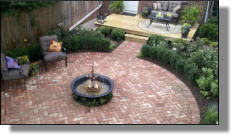 Small kettle and Lance One Iris fountain used as centerpiece of Alexandria, VA backyard renovation on DIY network show