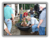 Testing one of the copper egret fountains made at the workshop.