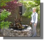 Nice stone surround with kettle as insert with heron fountain